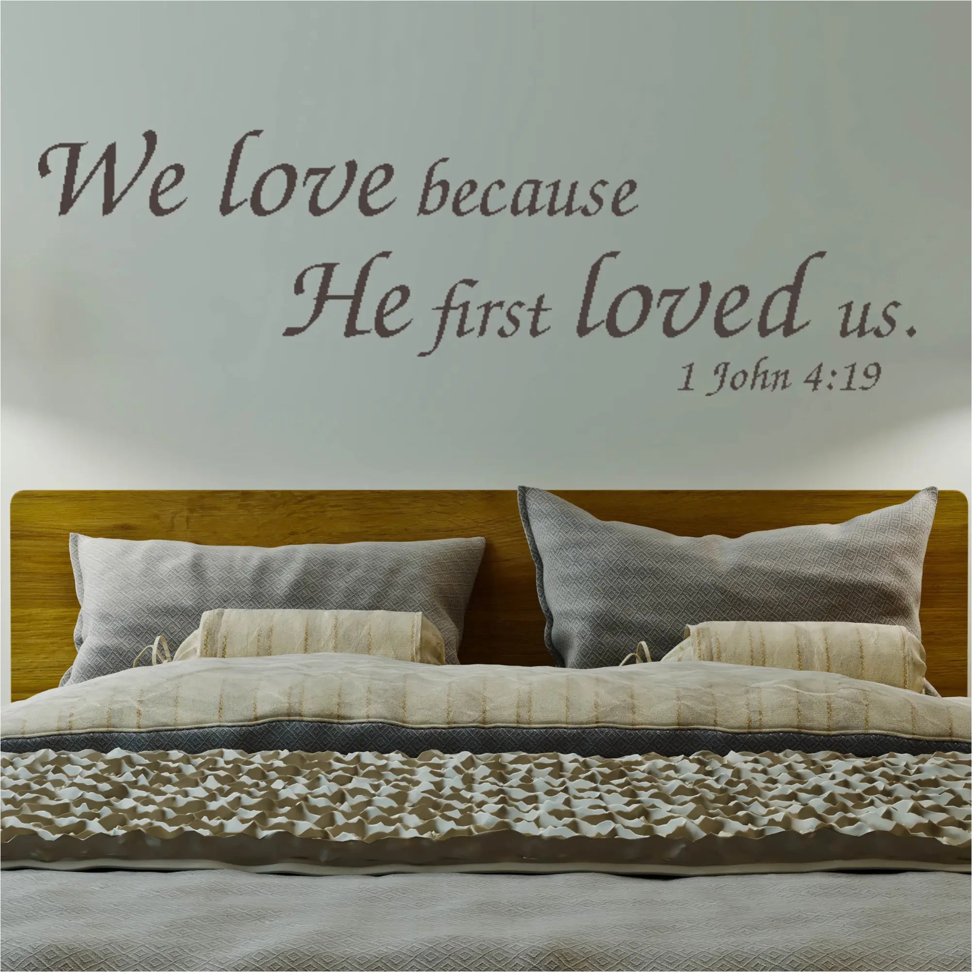 "We Love Because He First Loved Us" Bible Verse Wall Decal above a Bed. Creates a warm and inviting atmosphere in your Christian home decor.