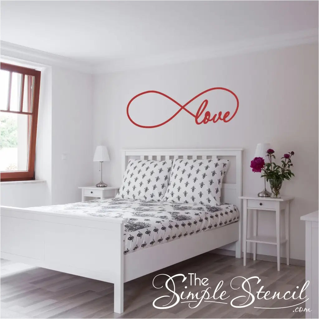 romantic red wall decal of an infinity symbol that incorporates the word "love" into the design and displayed in a beautiful master bedroom suite.