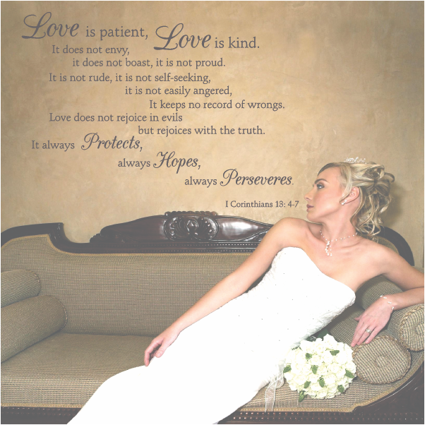 Love is patient, love is kind 1 Corinthians 13:4-7 wall decal above a vintage sofa with a bride posing in her wedding dress