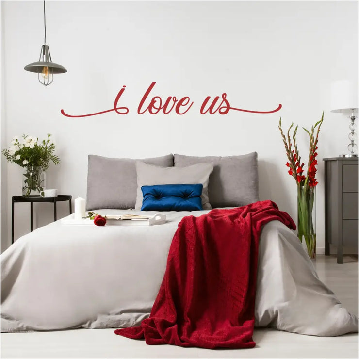 Beautifully scripted vinyl wall decal in a deep red color applied to a master bedroom wall over the bed adds a romantic touch to the beautiful room decor.