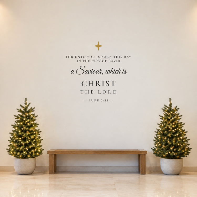 40 inch Luke 2:11 Christmas wall decal with gold star on a church foyer wall between lit Christmas trees