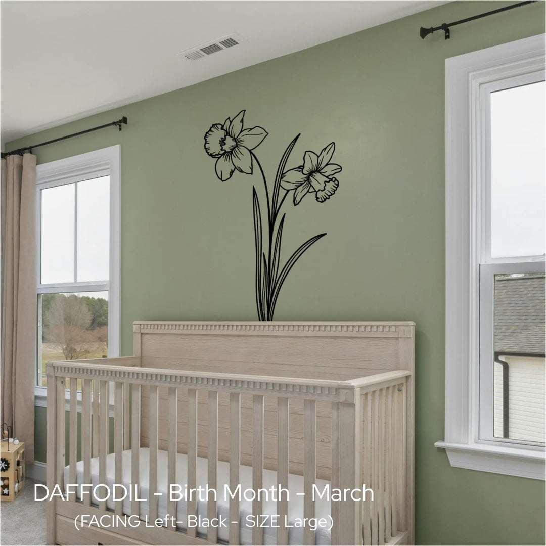 Black Daffodil line art wall graphic centered over a natural wood crib in a sage green, nature-inspired nursery.