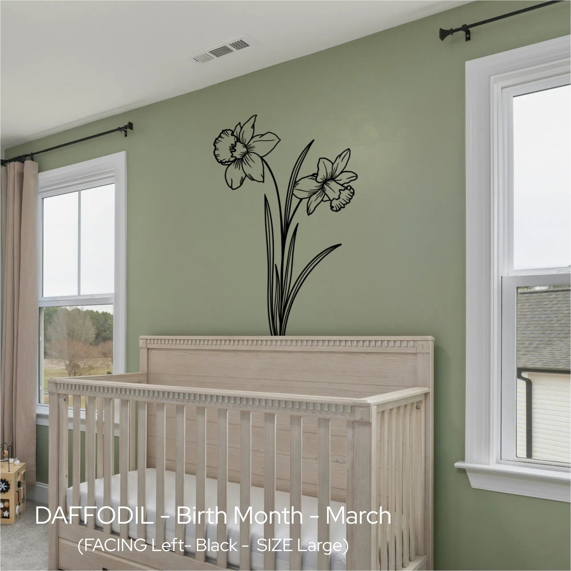 Black Daffodil line art wall graphic centered over a natural wood crib in a sage green, nature-inspired nursery.