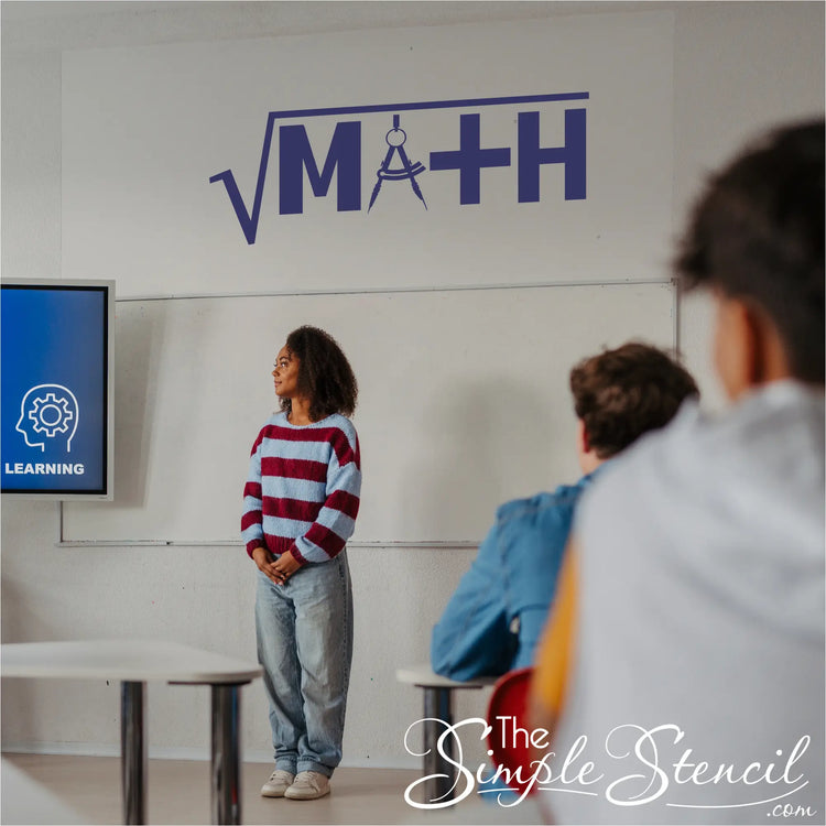 A blue MATH wall decal on a wall over a teacher teaching high school math to students
