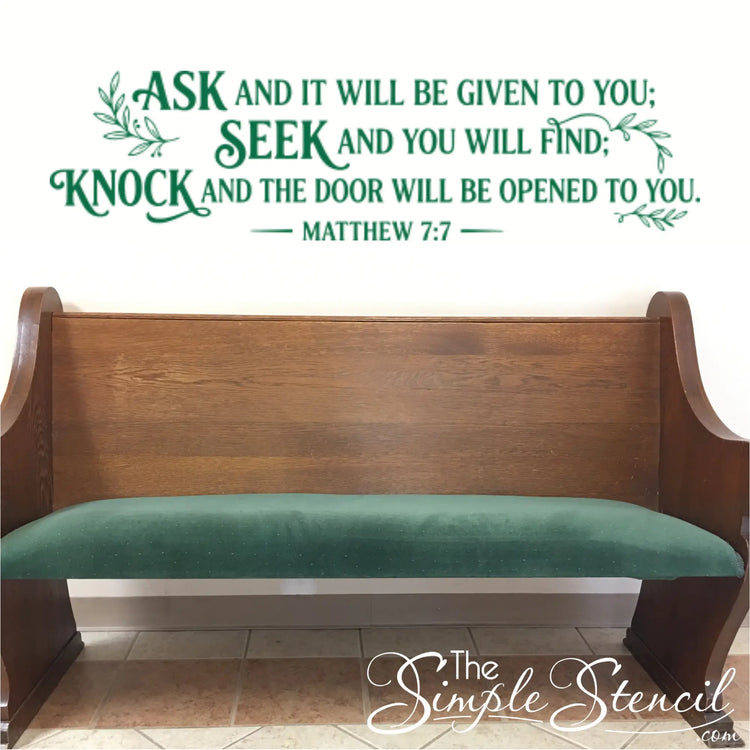 Large scripture wall decals for church sanctuary featuring Matthew 7:7 in rich forest green matte vinyl, installed perfectly centered on a white wall above a traditional wooden church pew.