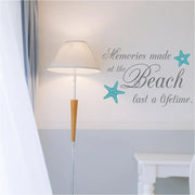 Memories made at the Beach last a lifetime. Vinyl wall decal on a beach house wall with aqua colored starfish decals alongside.