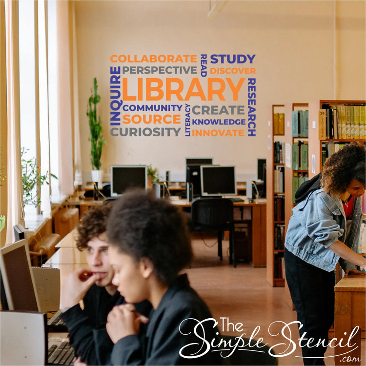 Vibrant orange and royal blue school library word cloud decal installed as an accent wall graphic in a high school media center.
