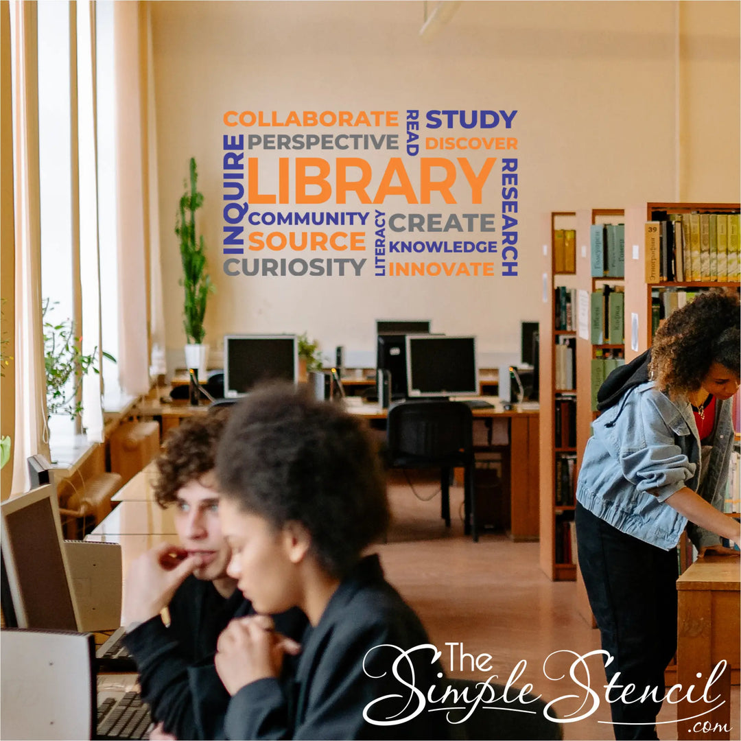 Vibrant orange and royal blue school library word cloud decal installed as an accent wall graphic in a high school media center.