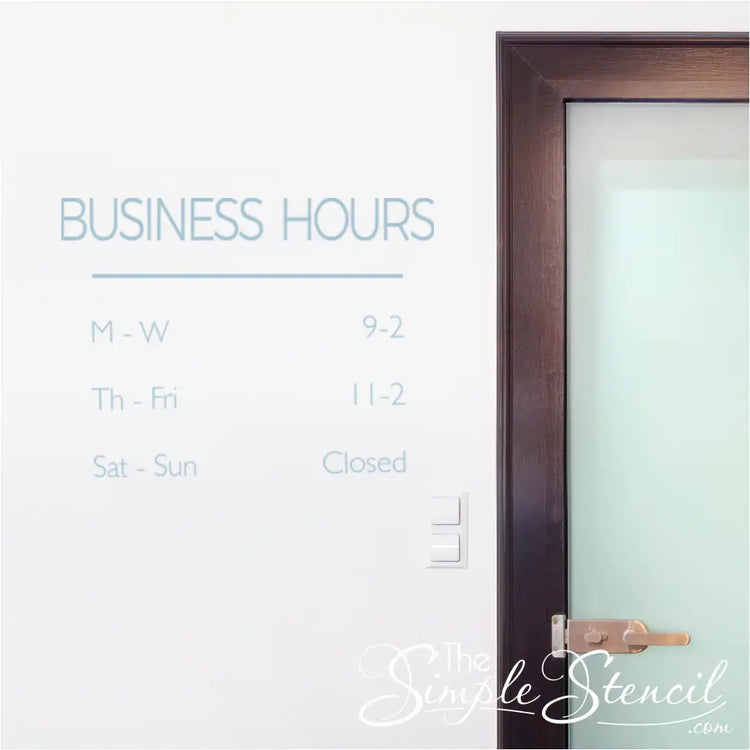 Business Hours wall decal shown on a wall next to an entryway door to announce hours in a clean stylish way.
