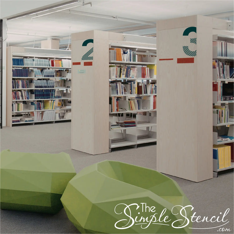 Large modern teal room numbers 2 and 3 applied to light wood library partitions in a contemporary educational space.