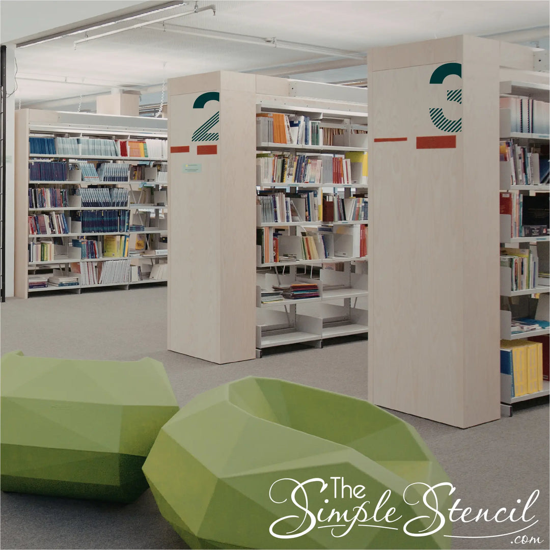 Large modern teal room numbers 2 and 3 applied to light wood library partitions in a contemporary educational space.