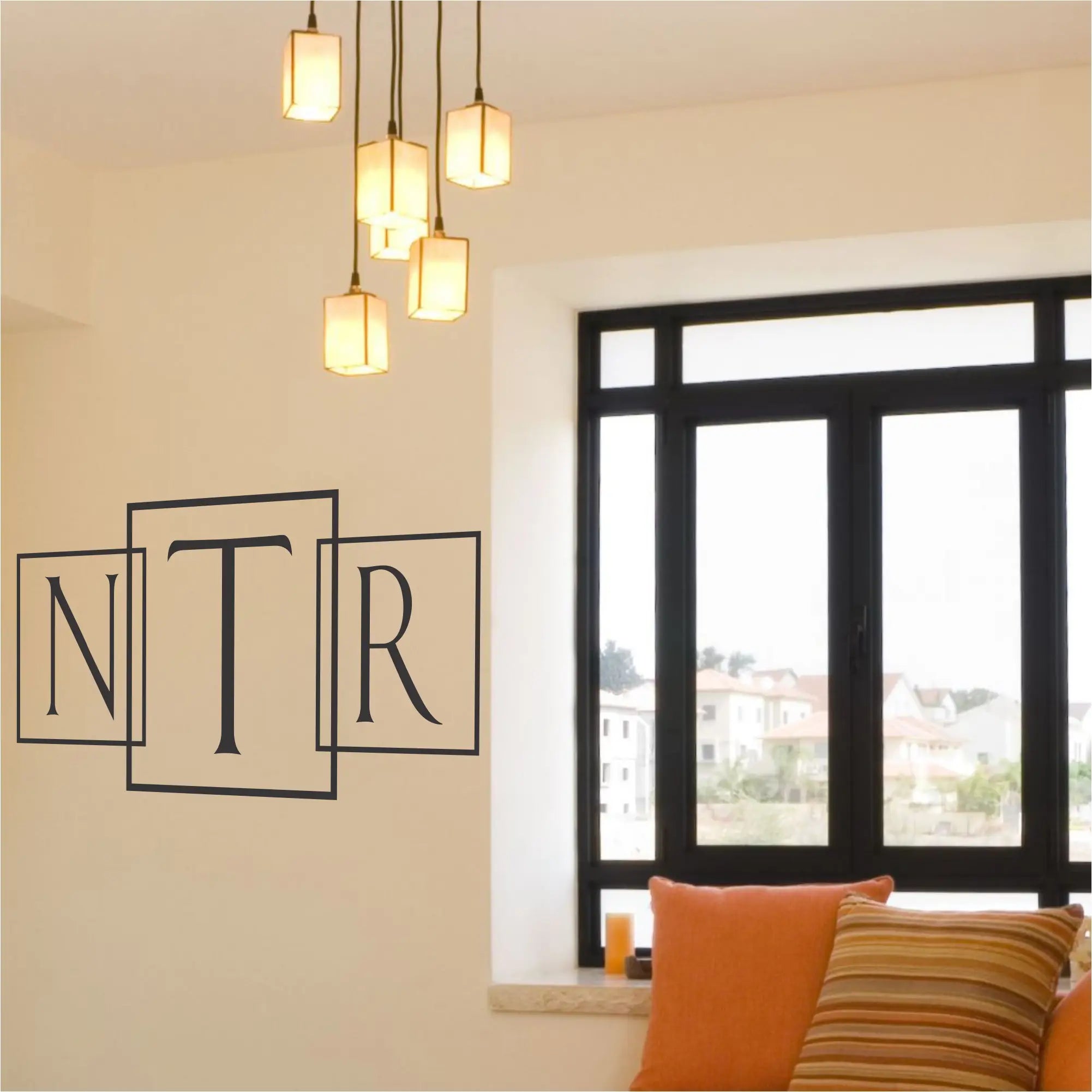 Single initial with box outline modern wall or window monogram applied to a wall in a creative way by using three different decals to spell out all three initials in name with the middle initial being larger in the center. Wow, this Simple Stencil customer did great! 