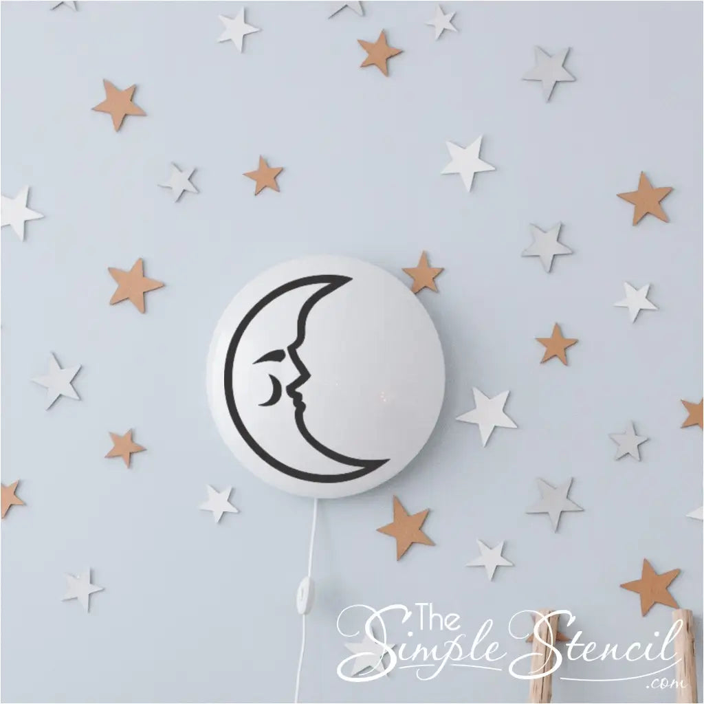 Sleepy moon decal applied to smooth plastic wall light to create custom diy baby nursery decor