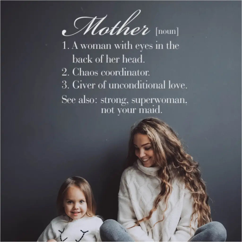 A funny Mother definition wall decal displayed on a wall over a mother and daughter posing. A fun reminder to why mom is so important to the family. Makes a great Mother's day gift