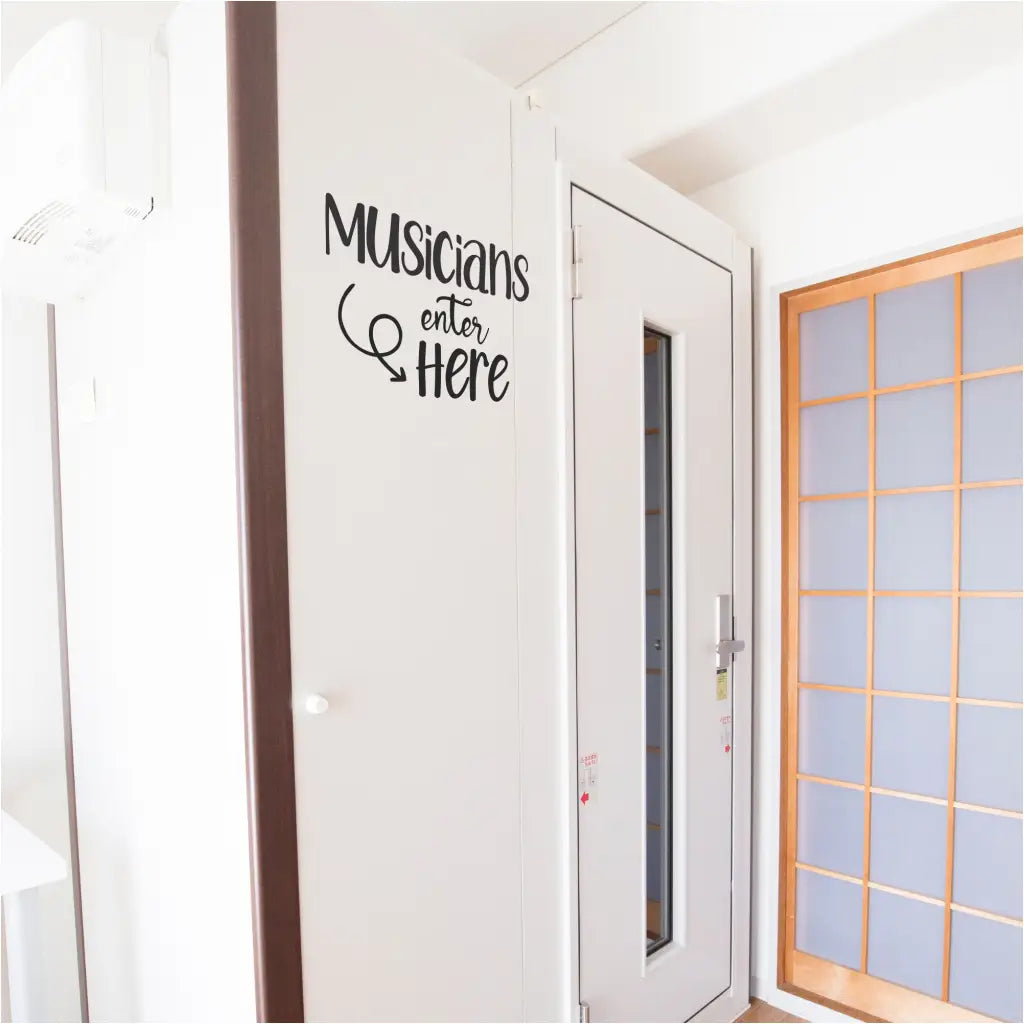 Colorful "Musicians Enter Here" vinyl decal adorns the entrance of a music studio, guiding musicians with a playful touch and adding a personalized flair to the creative workspace.
