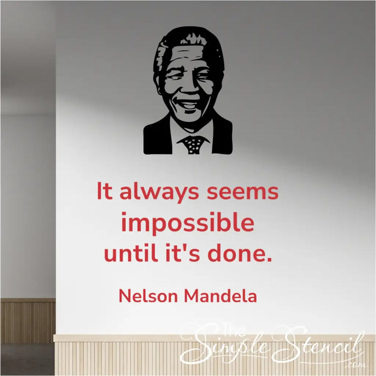 Red Nelson Mandela quote "It always seems impossible until it's done" wall decal in Modern font, placed next to a black silhouette image decal of Nelson Mandela, on a light-colored office hallway wall.