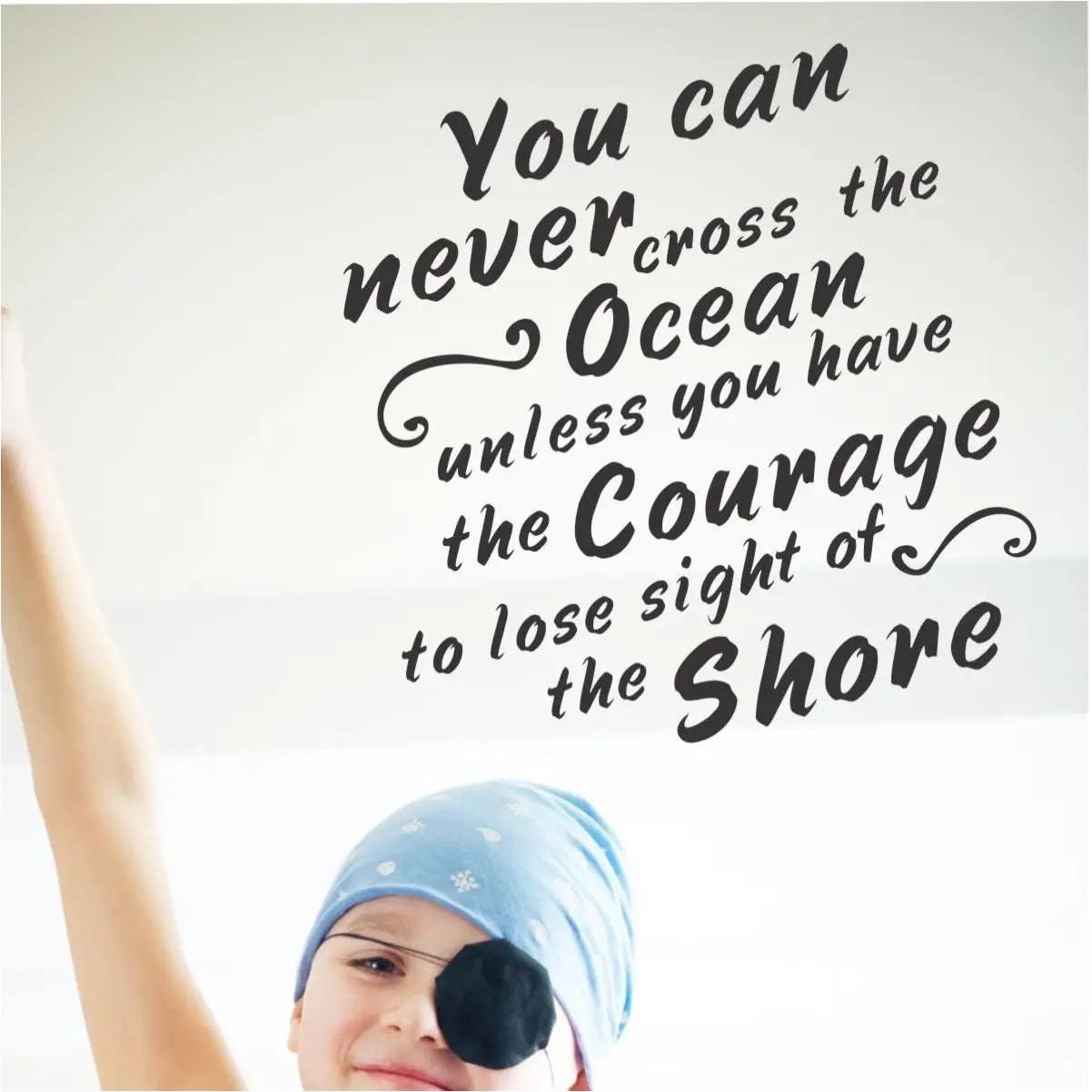 An inspiring wall quote decal by The Simple Stencil reads: You can never cross the ocean unless you have the courage to lose sight of shore.
