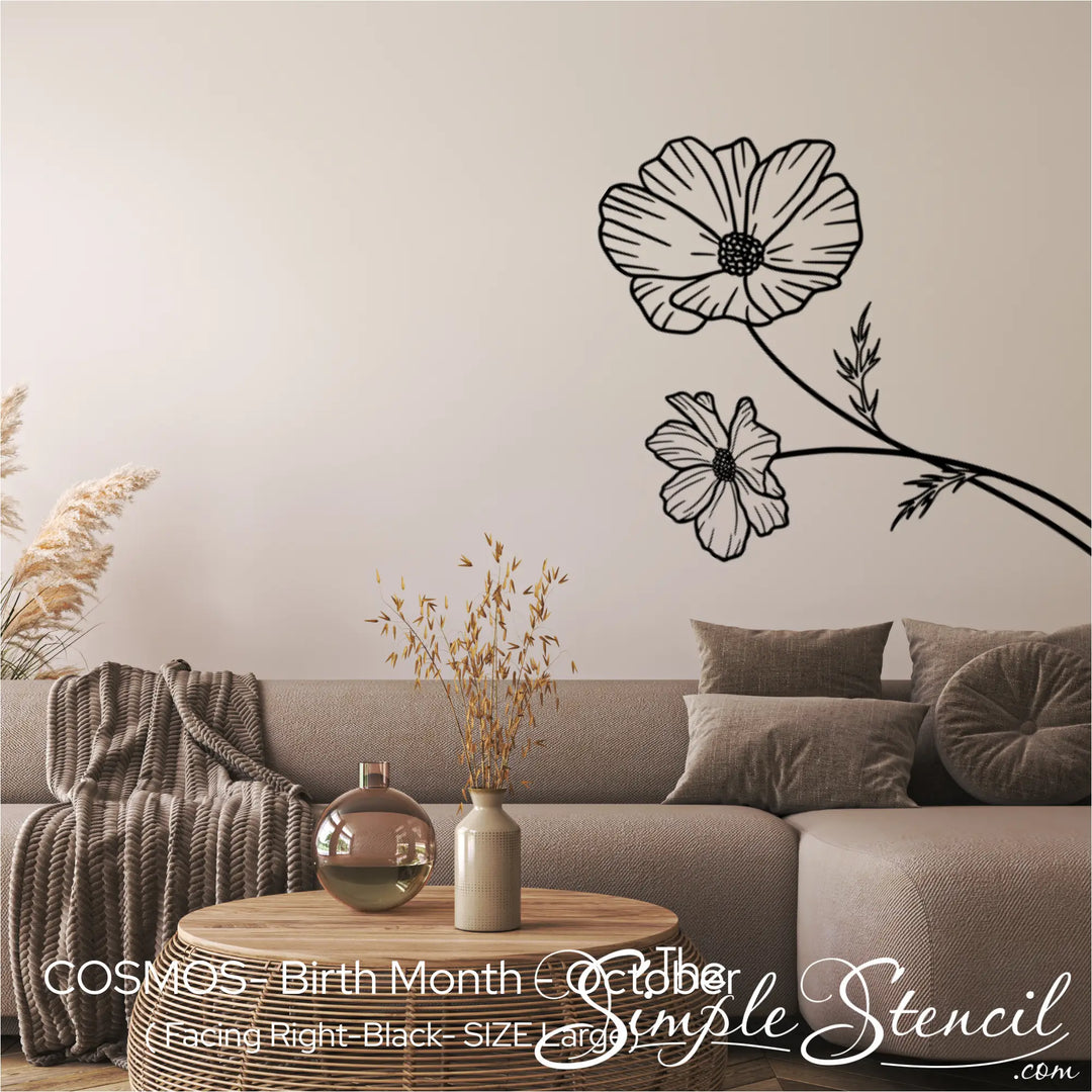 Large black Cosmos birth flower wall silhouette applied horizontally above a modern modular sofa in a neutral living room.