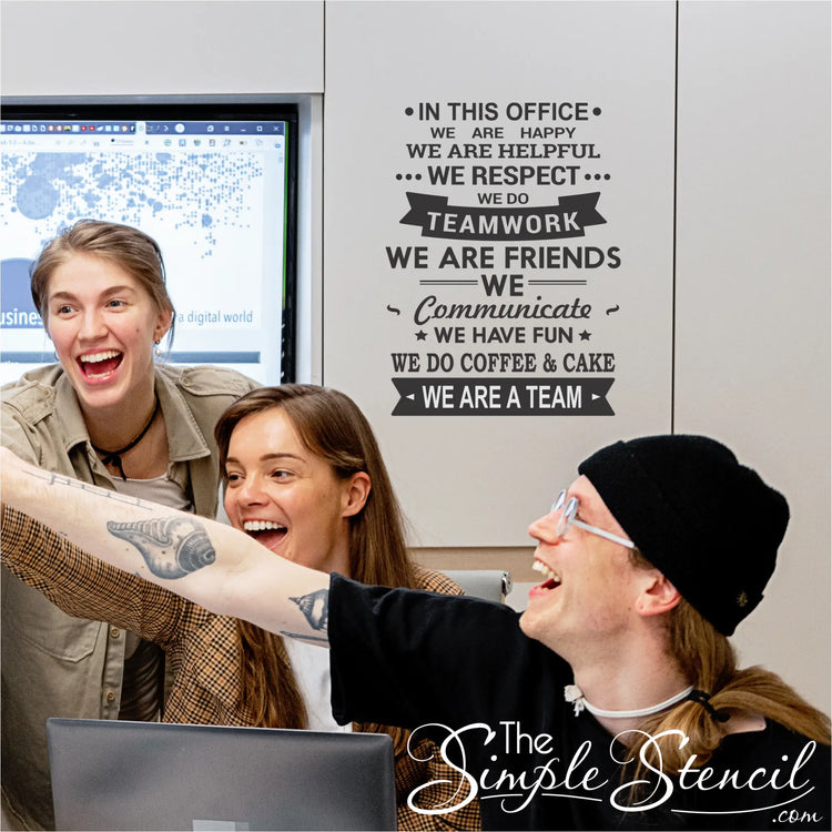 Image of the wall decor installed: "The wall decor mounted on a wall in an office setting, surrounded by happy employees."