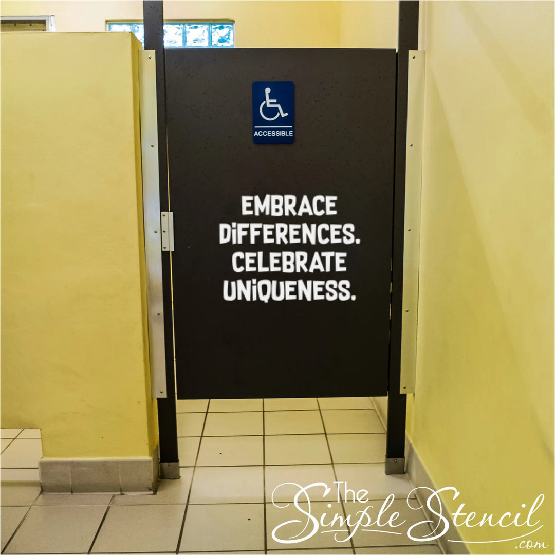 White vinyl decal on a black school restroom stall door reading Embrace Differences Celebrate Uniqueness for a positive bathroom transformation project.