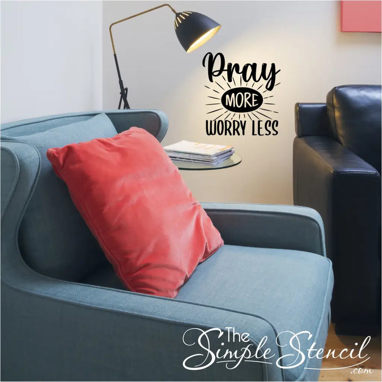 "Pray More Worry Less" wall decal on a living room wall