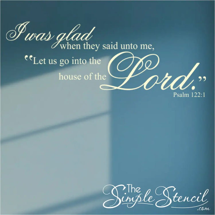 Ivory Psalm 122:1 'Let us go into the house of the Lord' decal applied to a deep blue accent wall, showcasing a high-contrast and modern spiritual display.