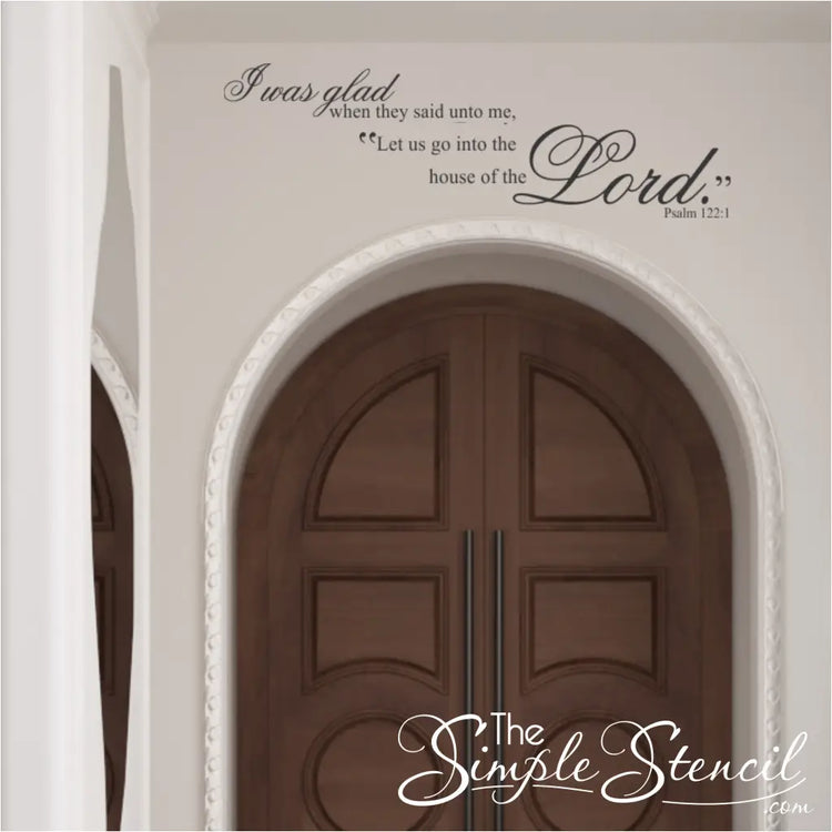 Scripture wall decal centered perfectly above a large, arched wooden church entryway, providing a professional and reverent welcome for congregants.