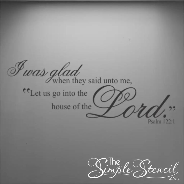 Black Psalm 122:1 scripture wall decal featuring elegant script typography, displayed on a minimalist dark grey wall with professional overhead spotlighting.