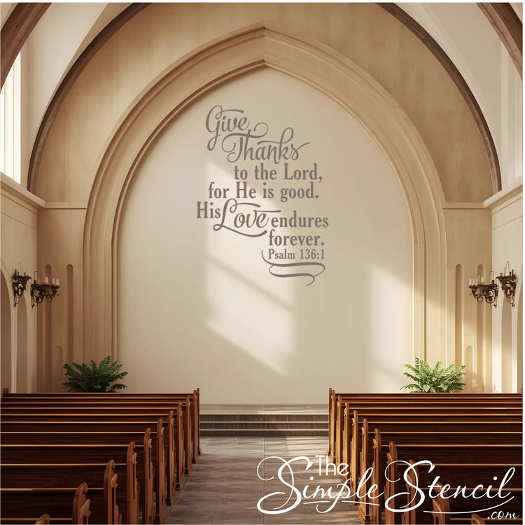 Church wall décor vinyl lettering of the Bible verse "Give thanks to the Lord" on a large, stone-colored arched wall above the altar/pulpit area.