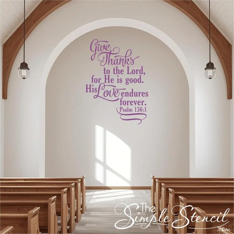 Large Psalm 136:1 religious wall stencil in light purple, applied to a white archway above pews in a bright, modern church sanctuary.