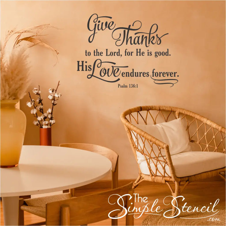 Psalm 136:1 wall decal applied above a sitting area in a cozy living room.