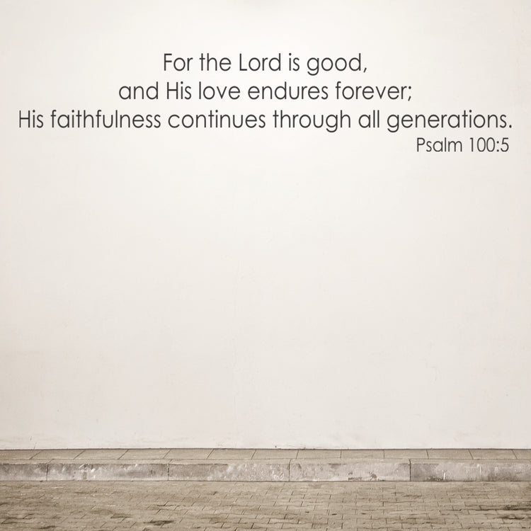Bible verse on a plain wall with a wooden floor.