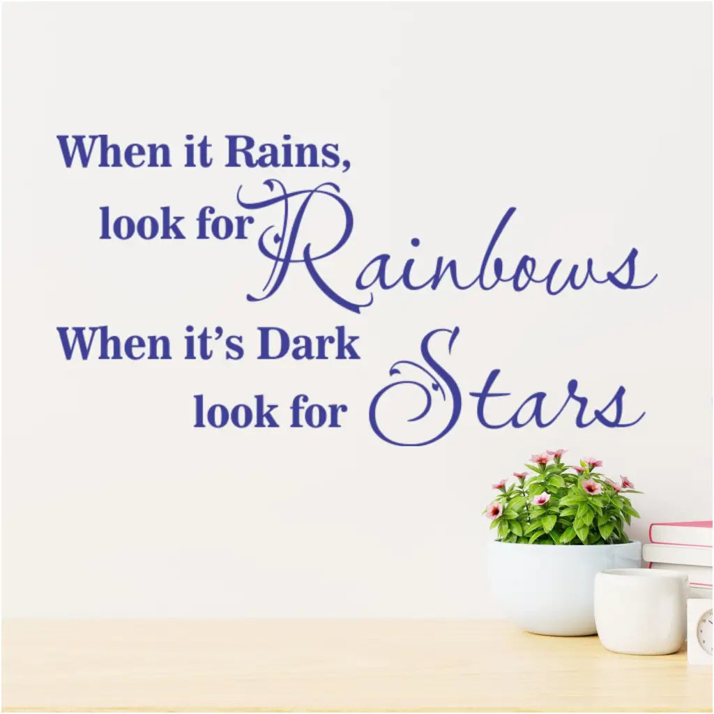 When it rains, look for rainbows. When it's dark, look for stars. An encouraging vinyl wall decal shown in Brilliant Blue on a wall over a desk. More colors and sizes at TheSimpleStencil.com