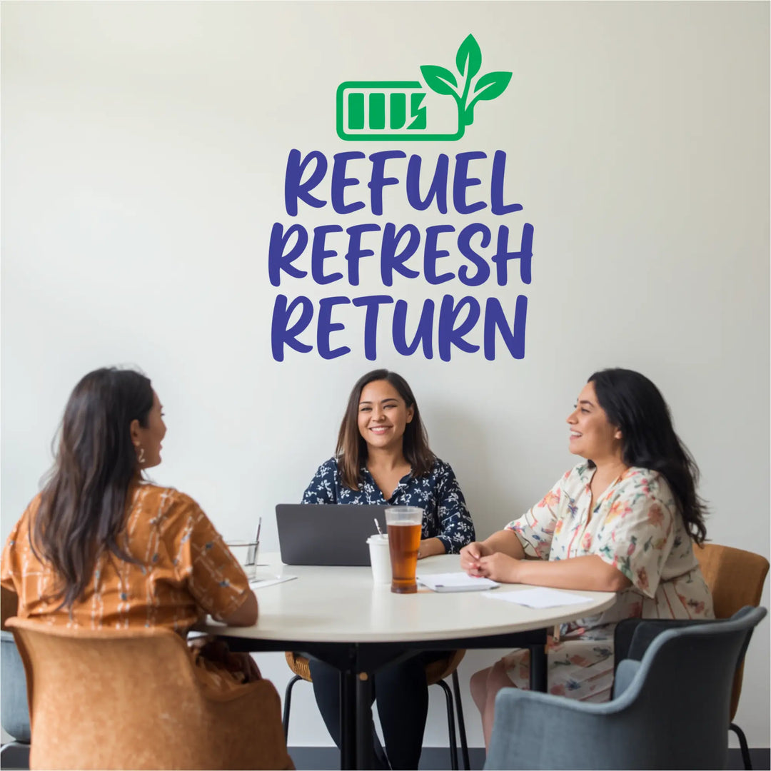 Motivational Refuel Refresh Return wall lettering in a school lounge above a group of teachers collaborating at a table.