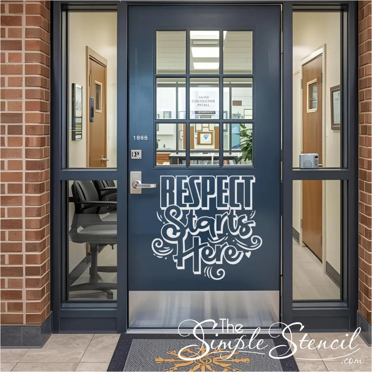 A white "Respect Starts Here" vinyl decal on a dark blue glass-paneled school entrance door, surrounded by brick walls and a welcome mat, signifying a respectful school environment from the exterior.