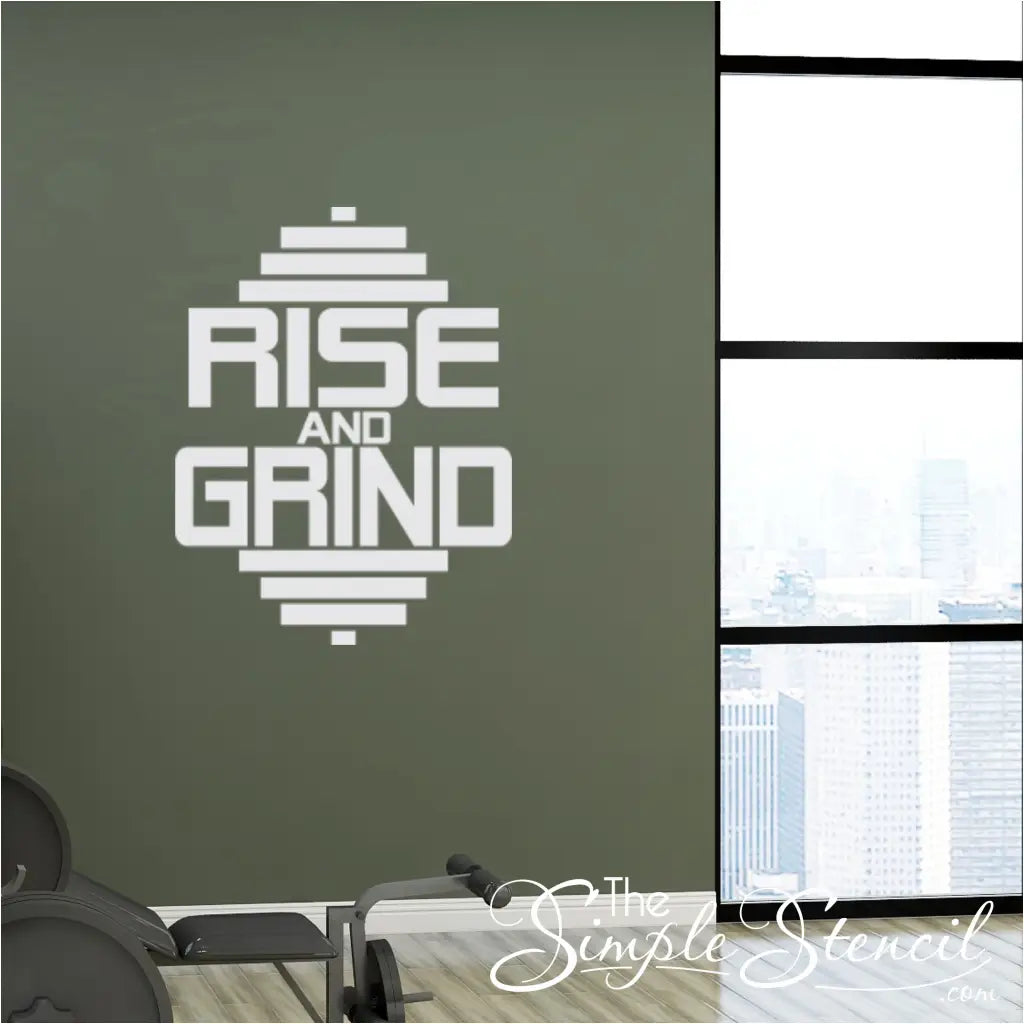 Black and white RISE AND GRIND Gym Wall Decal adding a modern touch to a garage gym.