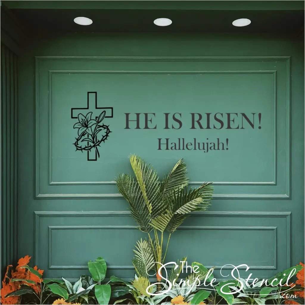 The 'He Is Risen! Hallelujah!' resurrection cross decal in black, displayed centered on a large, deep green paneled wall, ideal for a church lobby or sanctuary backdrop.
