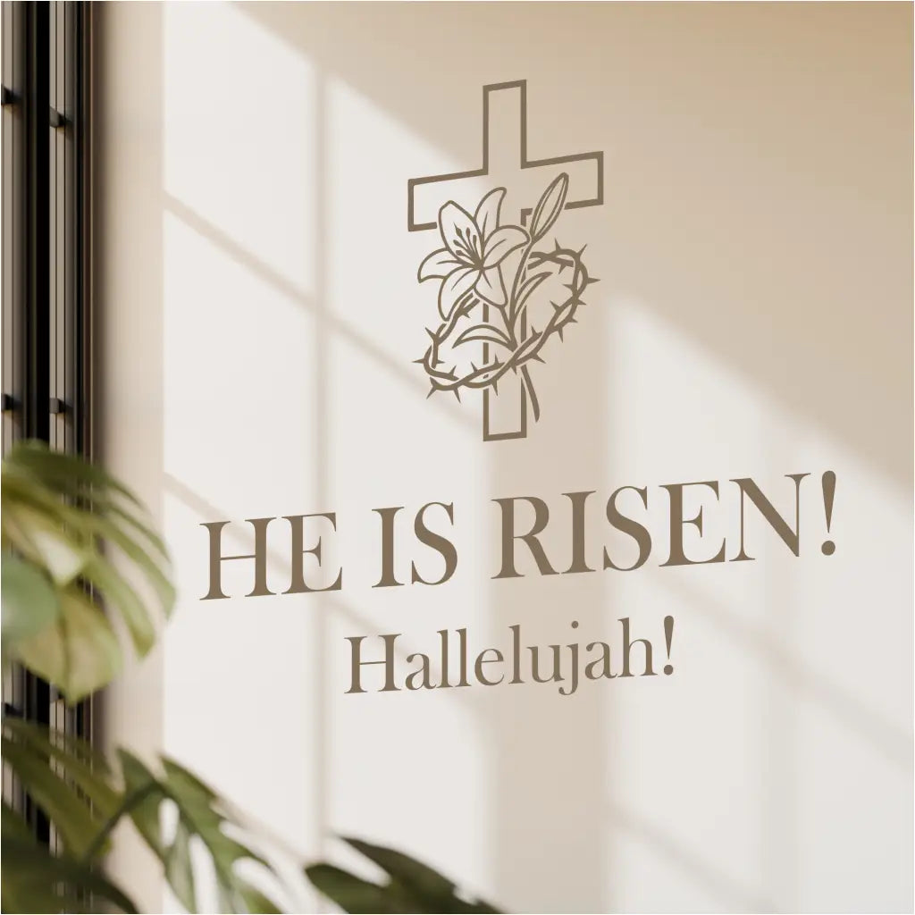 Close-up mockup of the 'He Is Risen!' Easter decal in a neutral taupe, applied to a modern textured wall with soft, natural sunlight and shadows.