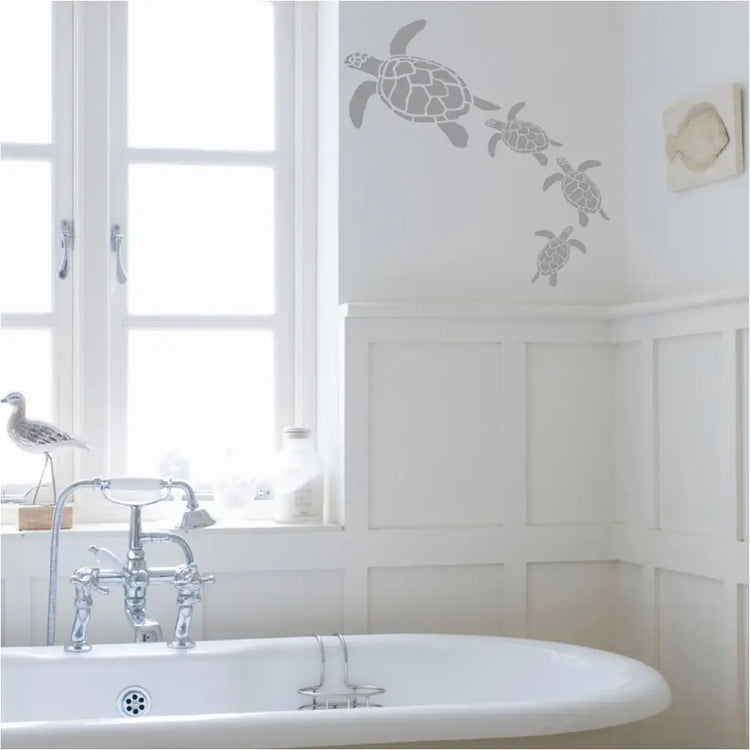 Sea turtle wall decal art by The Simple Stencil applied to a beautiful bathroom wall with other nautical decor. 