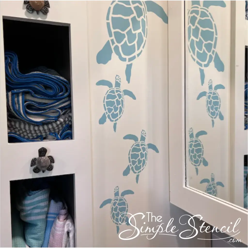Picture of sea turtle wall decals by TheSimpleStencil installed on a customers bathroom wall near a linen shelf. Easy install of these sweet little swimming sea turtles come in many sizes and colors for just about any decor project.