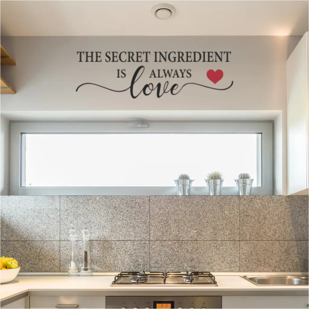 The secret ingredient is always love wall decal in black with red heart over a kitchen cooking area