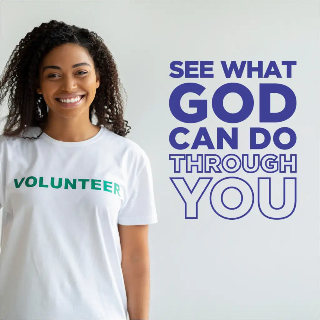 Inspirational Christian wall decal reading 'See What God Can Do Through You' displayed next to a smiling church volunteer in a white t-shirt, perfect for mission and recruitment stations.
