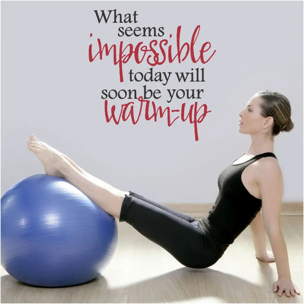 Two color wall quote decal on a fitness center wall with a girl working out that reads: What seems impossible today will soon be your warm up.