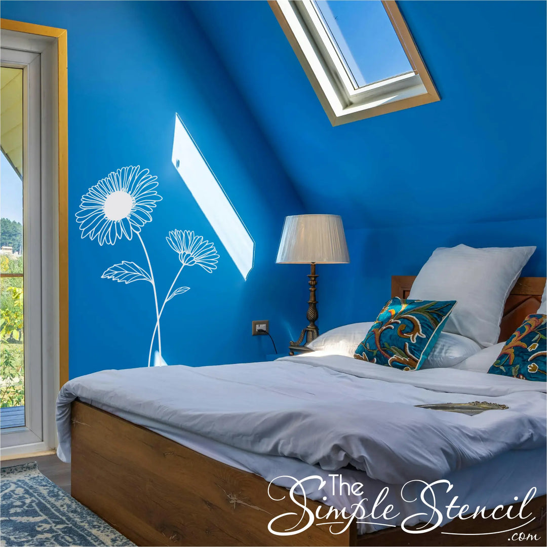 White Aster birth flower wall lettering applied to a bold blue bedroom wall under a skylight for a nature-inspired look.