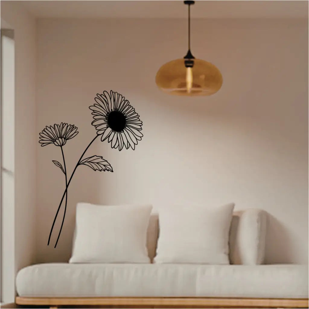 Large black Aster flower wall lettering placed above a neutral sofa in a calm, biophilic living room.