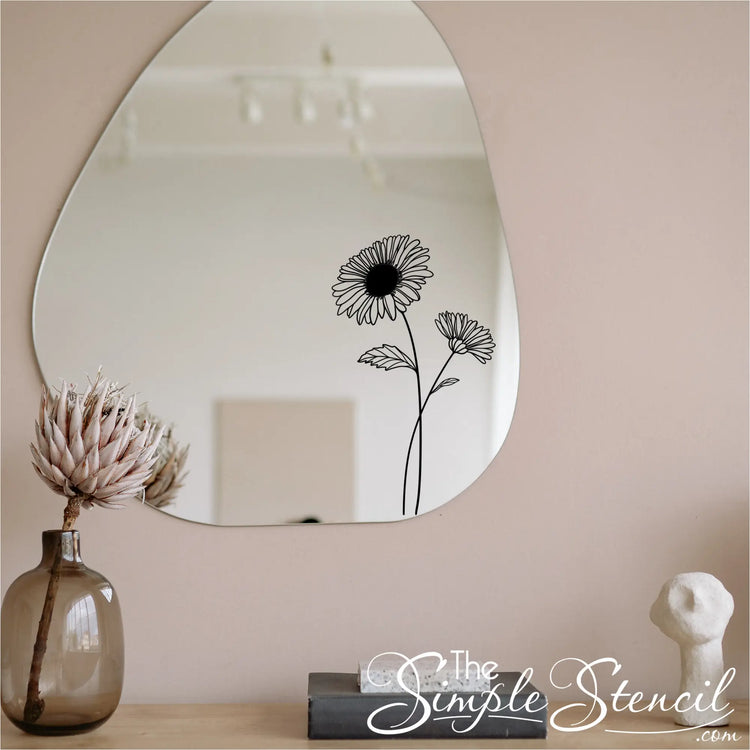 Minimalist Aster flower botanical decal applied to a modern organic-shaped mirror in a slow living home entryway.