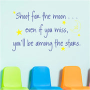 Inspirational quote for classroom that reads: Shoot for the moon... even if you miss you'll be among the stars. Available in many colors and sizes to match decor as shown here on a school wall in brilliant blue with yellow stars and moon. By The Simple Stencil 2000x2000