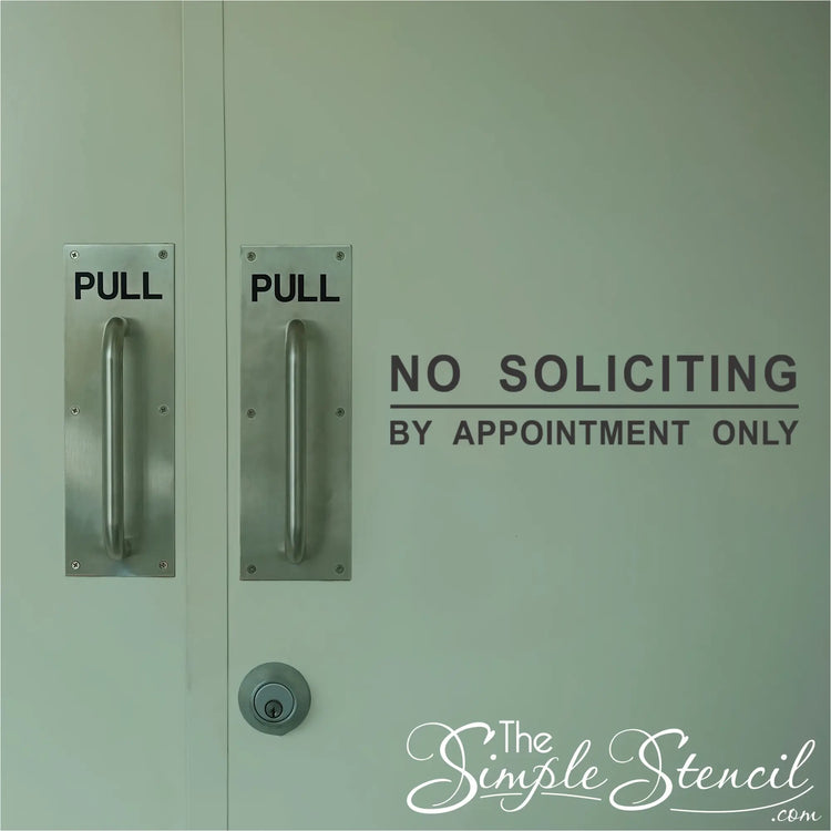 No Soliciting By Appointment Only decal applied to a store front door near the opening for easy reading.