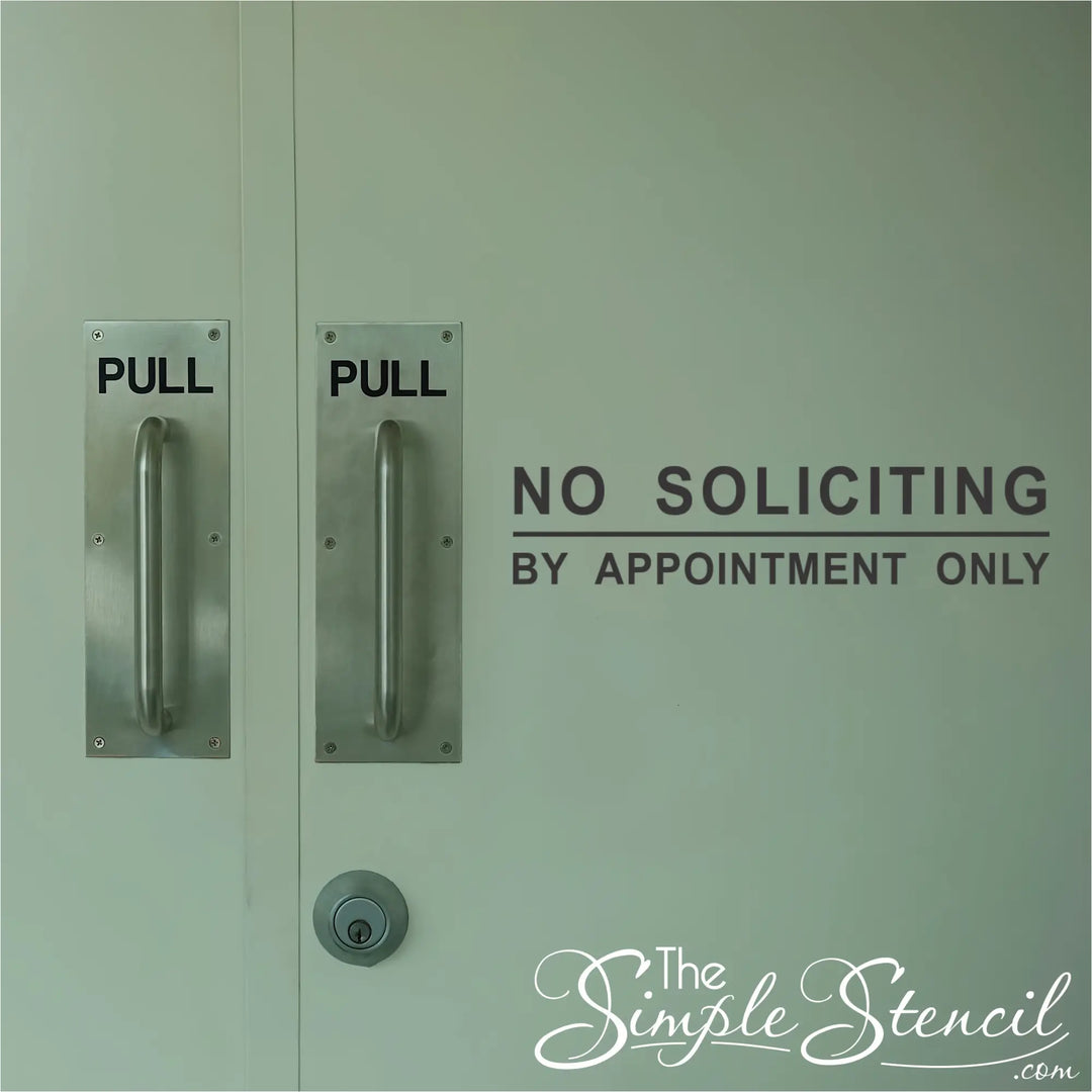 No Soliciting By Appointment Only decal applied to a store front door near the opening for easy reading.