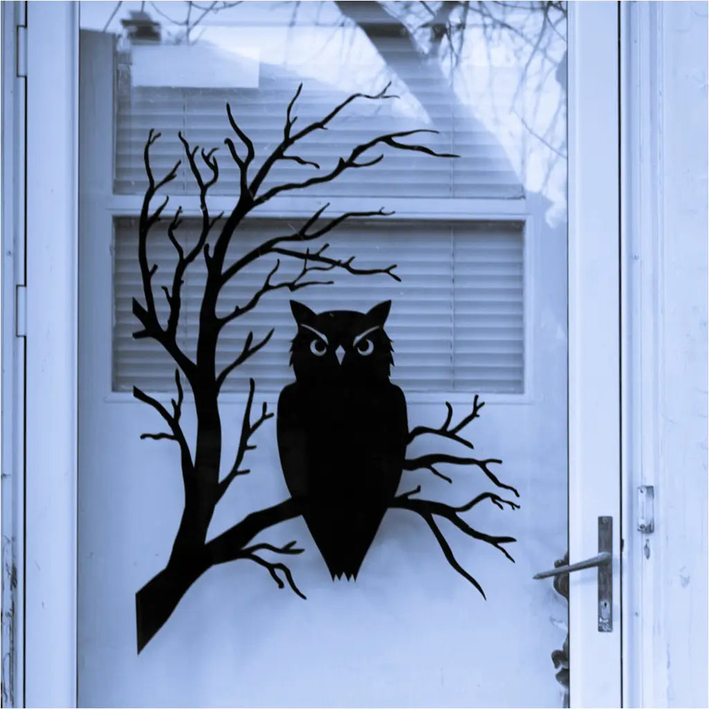 Close-up of a spooky owl wall decal with intricate details, featuring piercing eyes and feathery textures while perched on a spooky tree branch